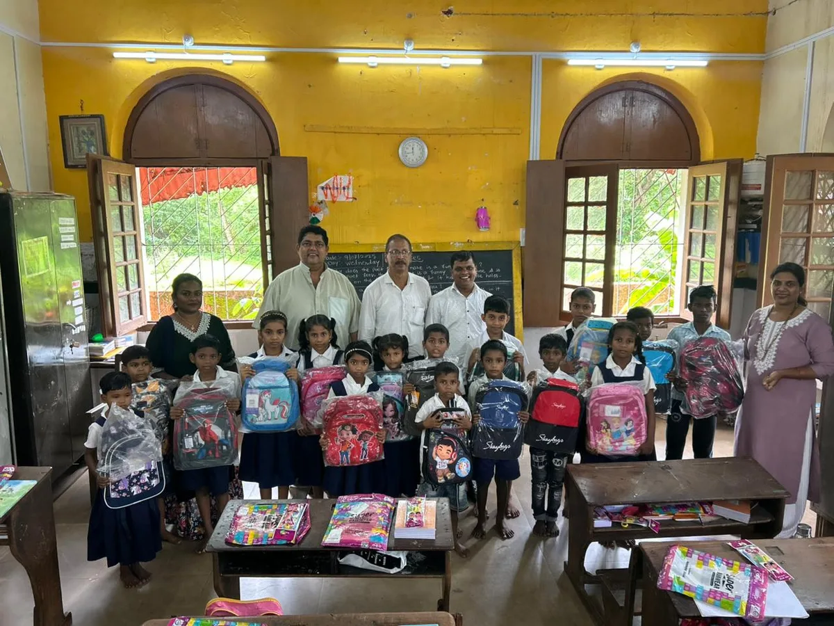 Schoolchildren receiving free school bags and stationery kits